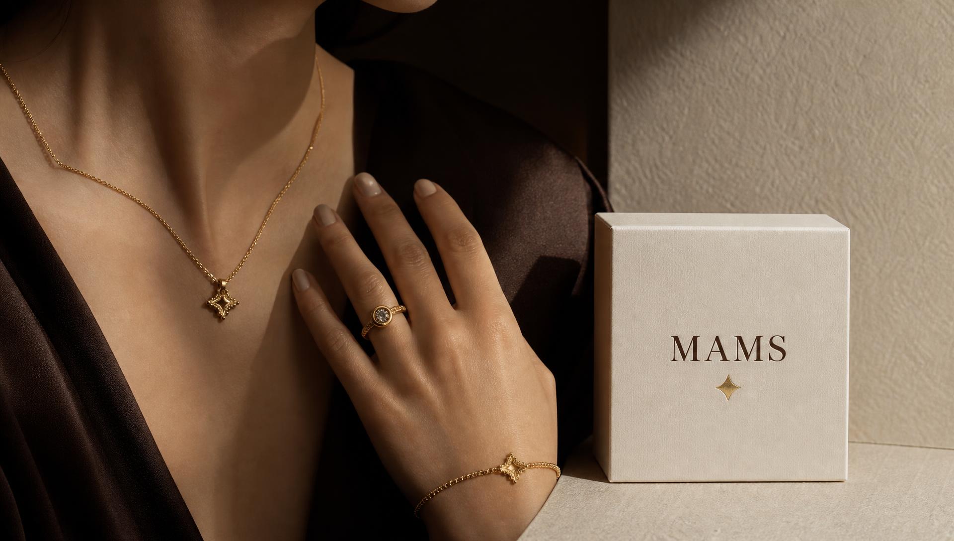 A MAMS gold necklace resting on ivory silk